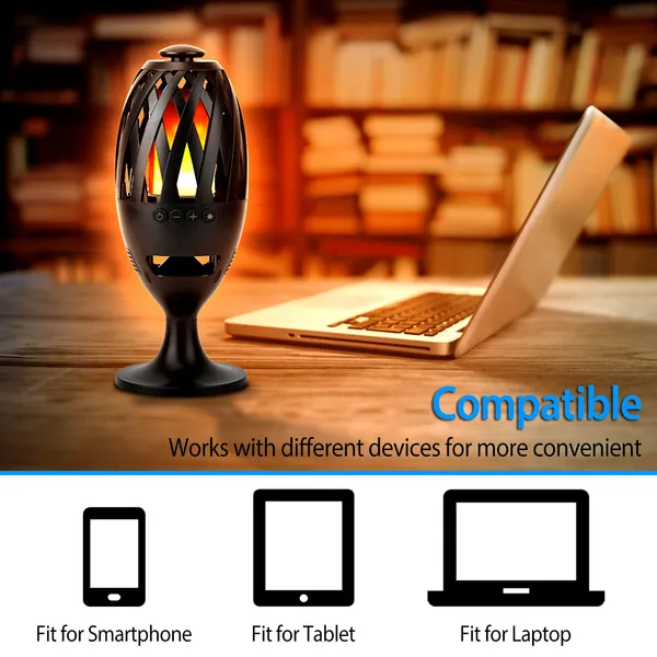 Flame speaker next to a laptop