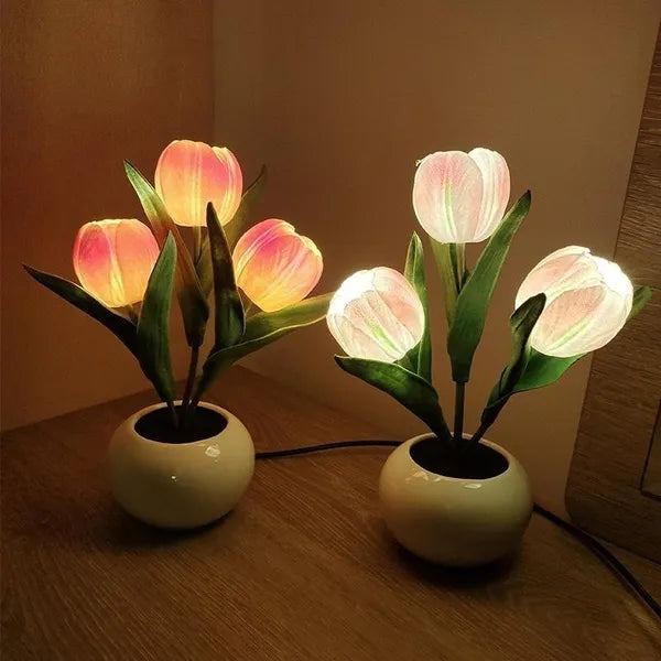 Glowing tulip lamps on a nightstand